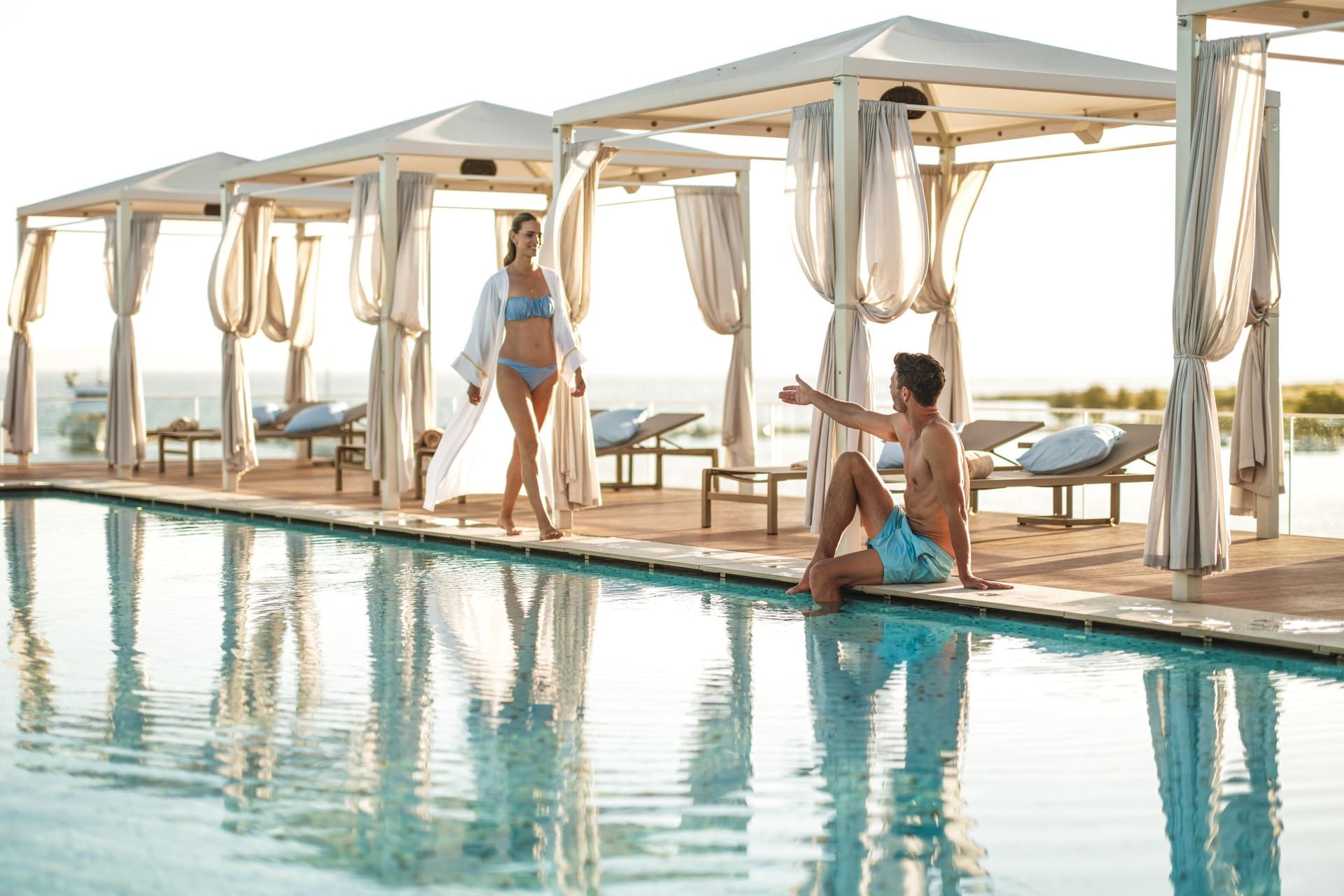 A young couple by the pool at Zaton Holiday Resort, enjoying a peaceful sunset. Ventula Family Deluxe Package